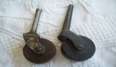 Two antique furniture casters and wheels